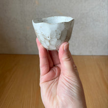 Load image into Gallery viewer, Espresso cup in hand showing facets, rim and size