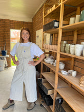 Load image into Gallery viewer, Person wearing a Walking Apron in Orange NSW pottery studio — exclusive Australian stockist
