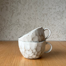 Load image into Gallery viewer, side view of speckled cap cups showing rims and handles

